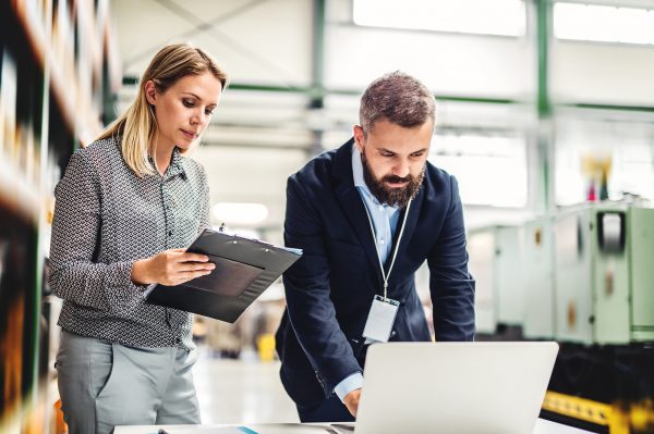 A Portrait Of An Industrial Man And Woman Engineer With Laptop I
