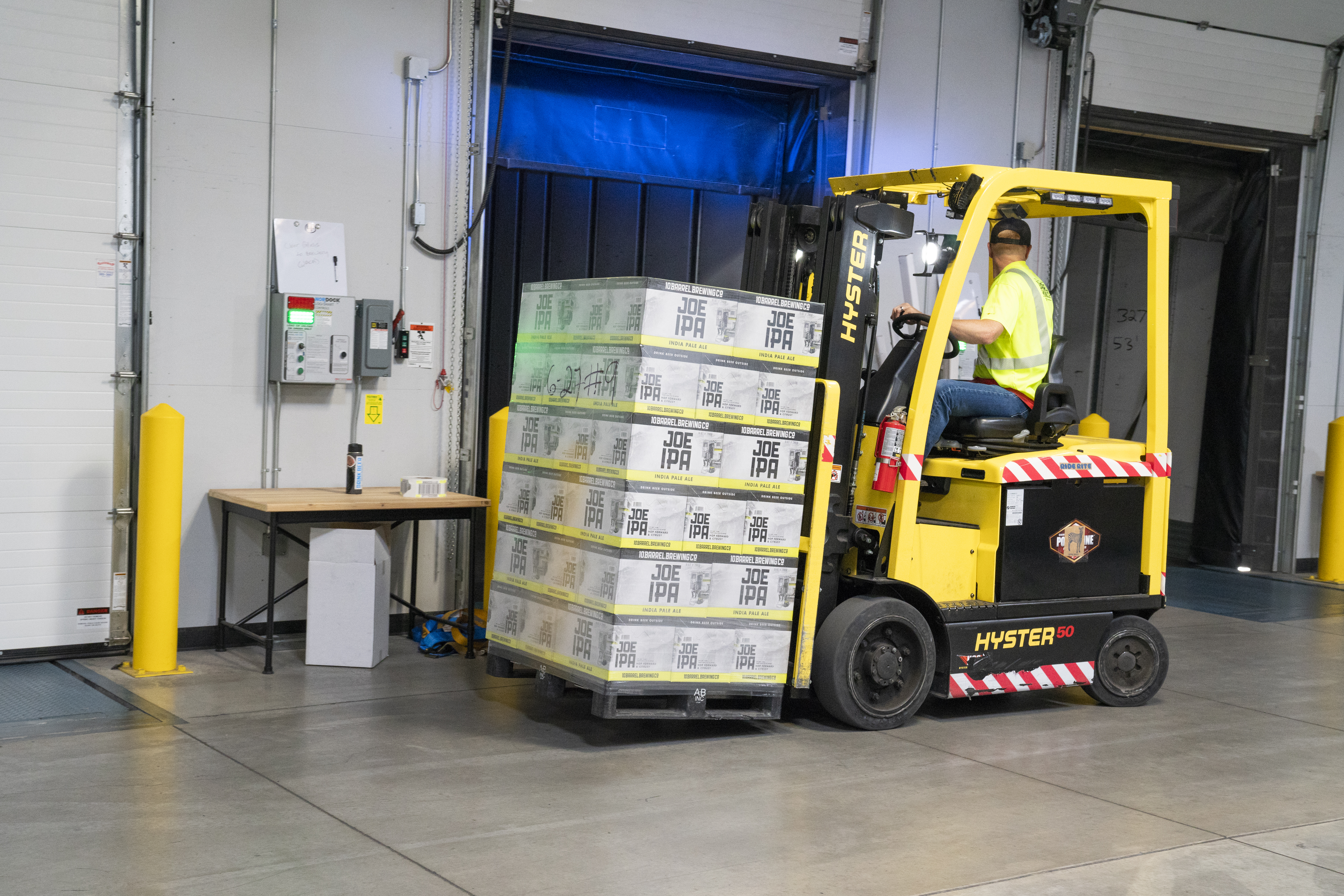 man-riding-on-yellow-forklift-1267329
